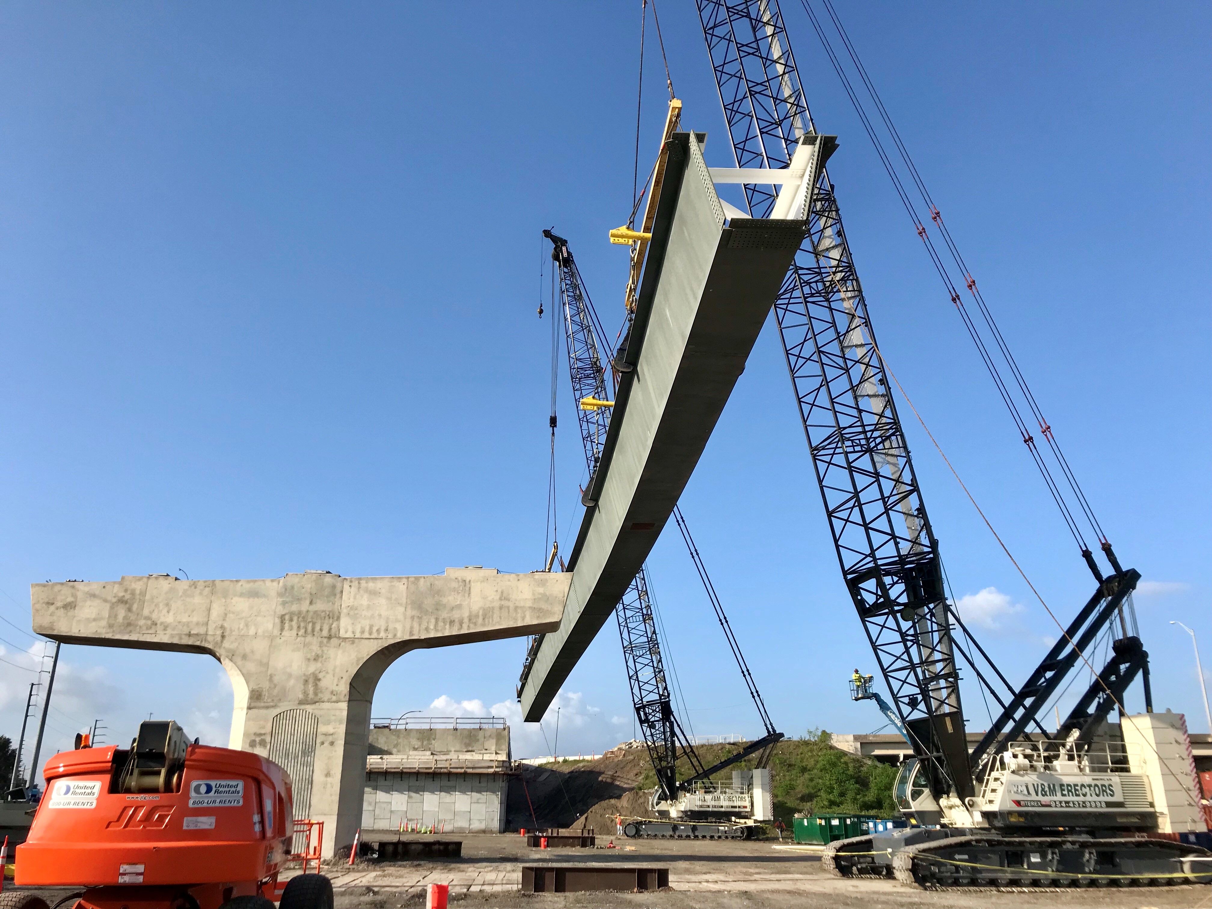 Tub girder being threaded between bridge bents
