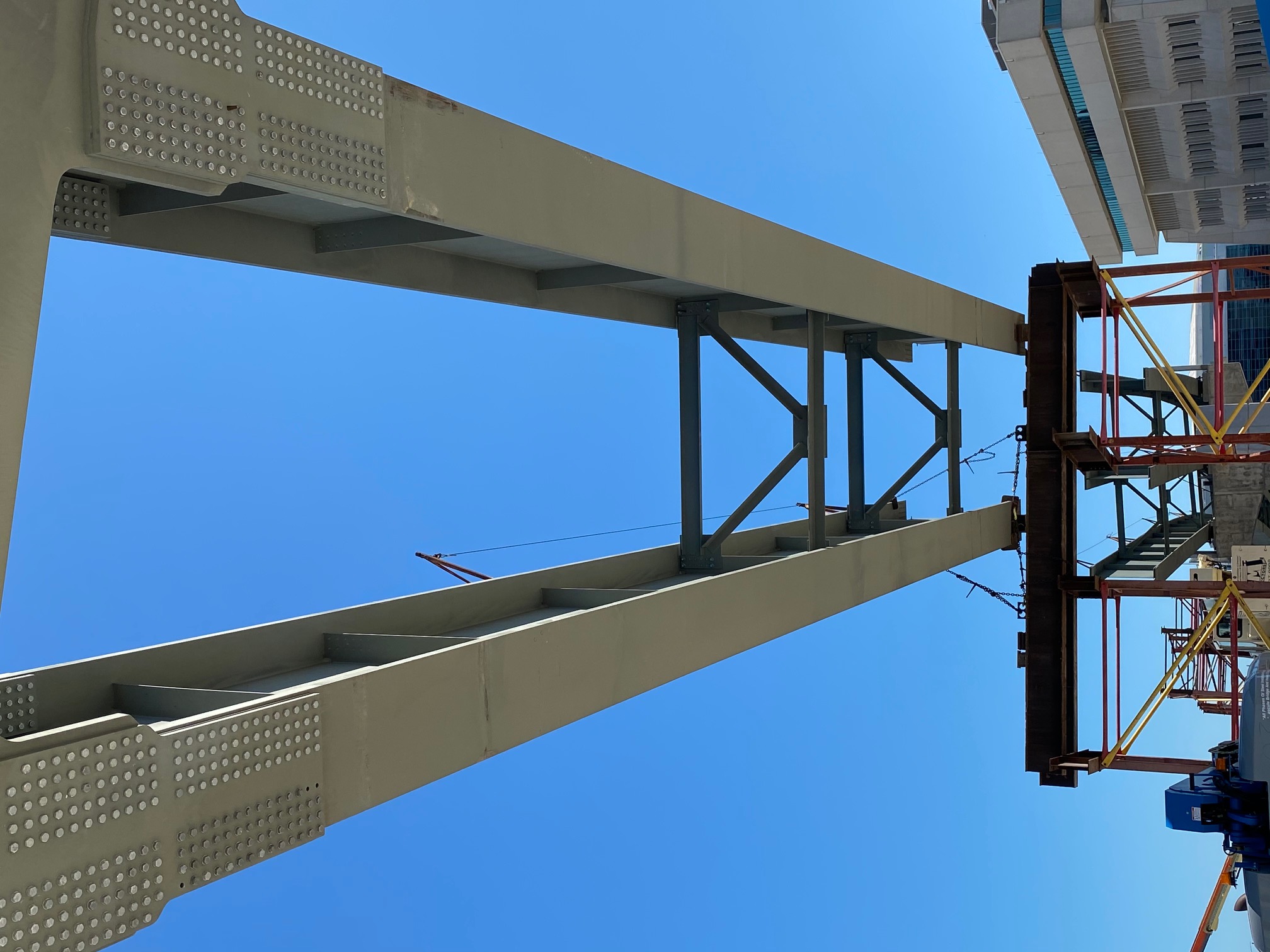 Looking up at a steel girder underside with bolted splice details